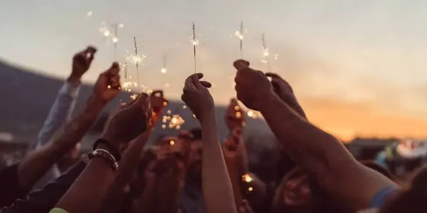 group holding sparkler firworks