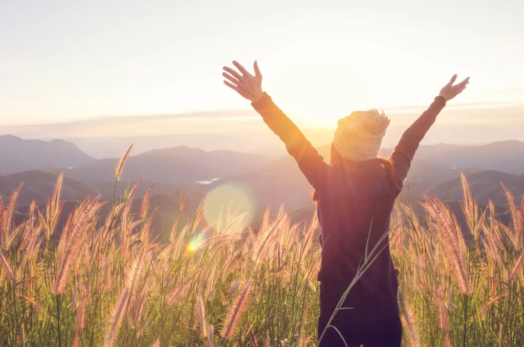 woman on top of mountain after a hike  bipolar disorder treatment