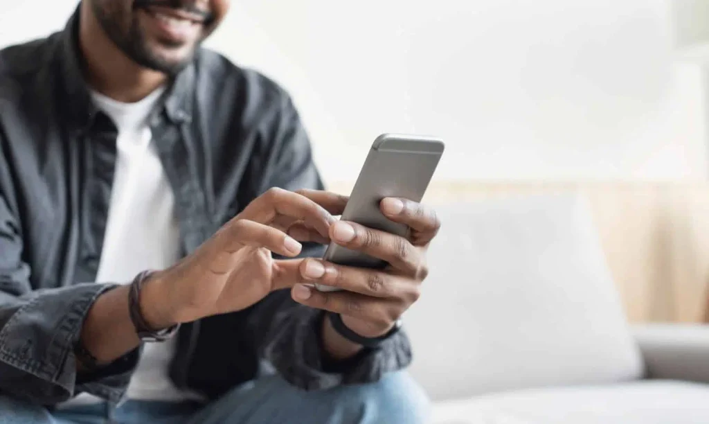 man filling out insurance form on phone