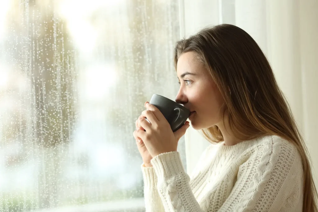 woman with social anxiety staring out window