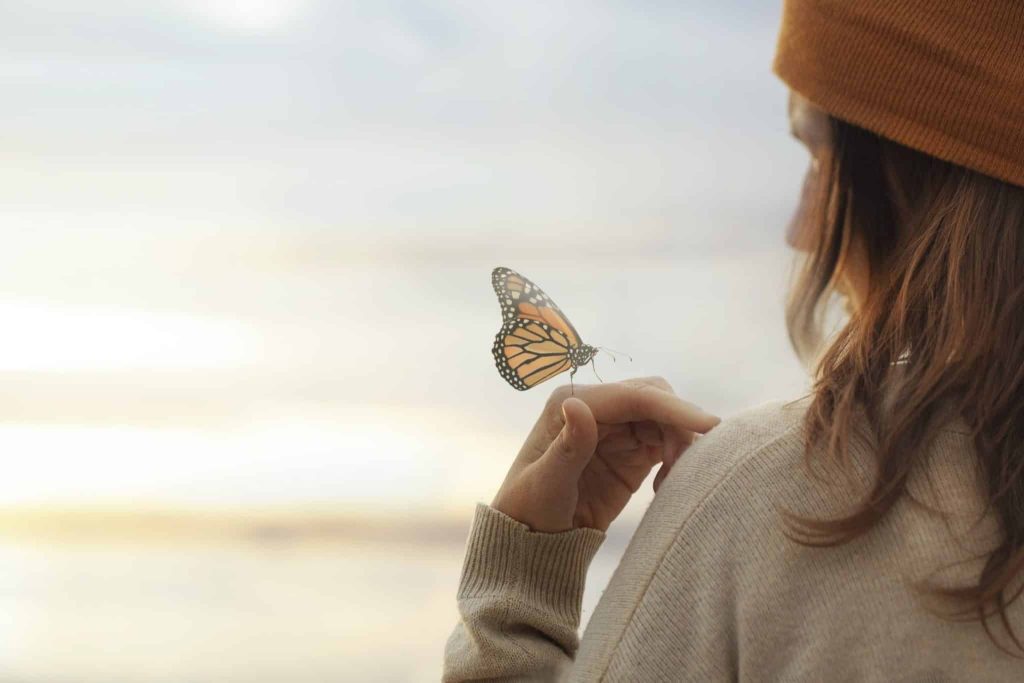 woman holding butterfly outside Schizoid Personality Disorder