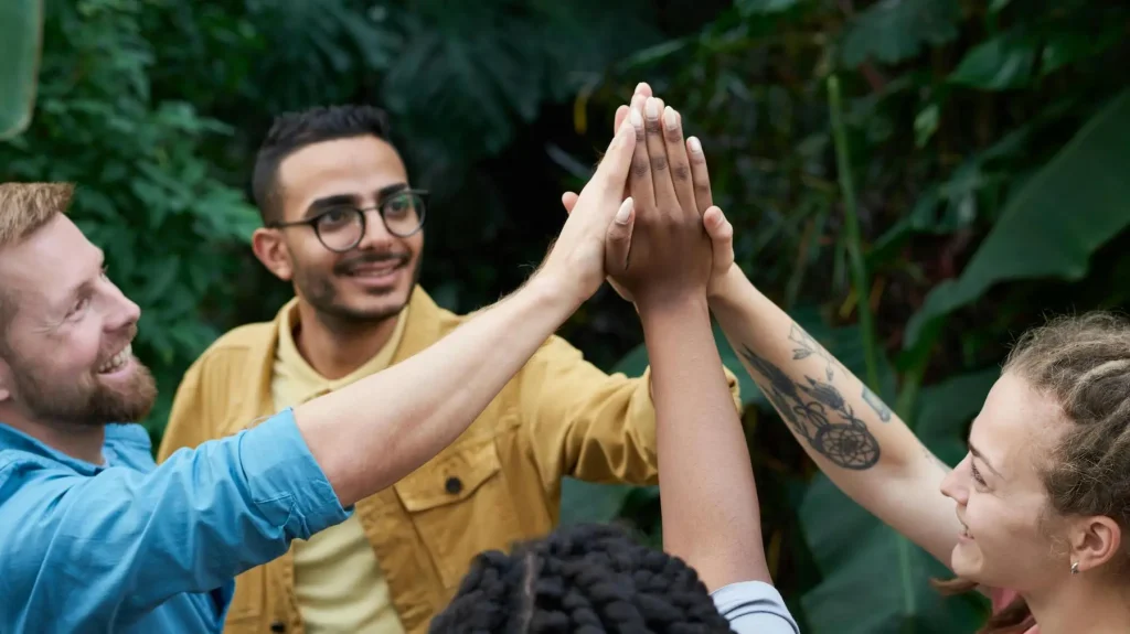 a group of people giving each other a high five