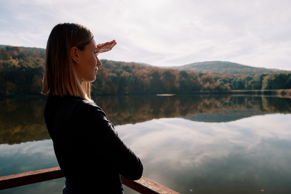 woman looking out at lake