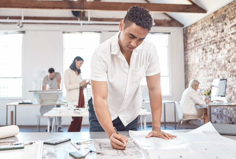 man with adhd at work in sacramento working on a blueprint