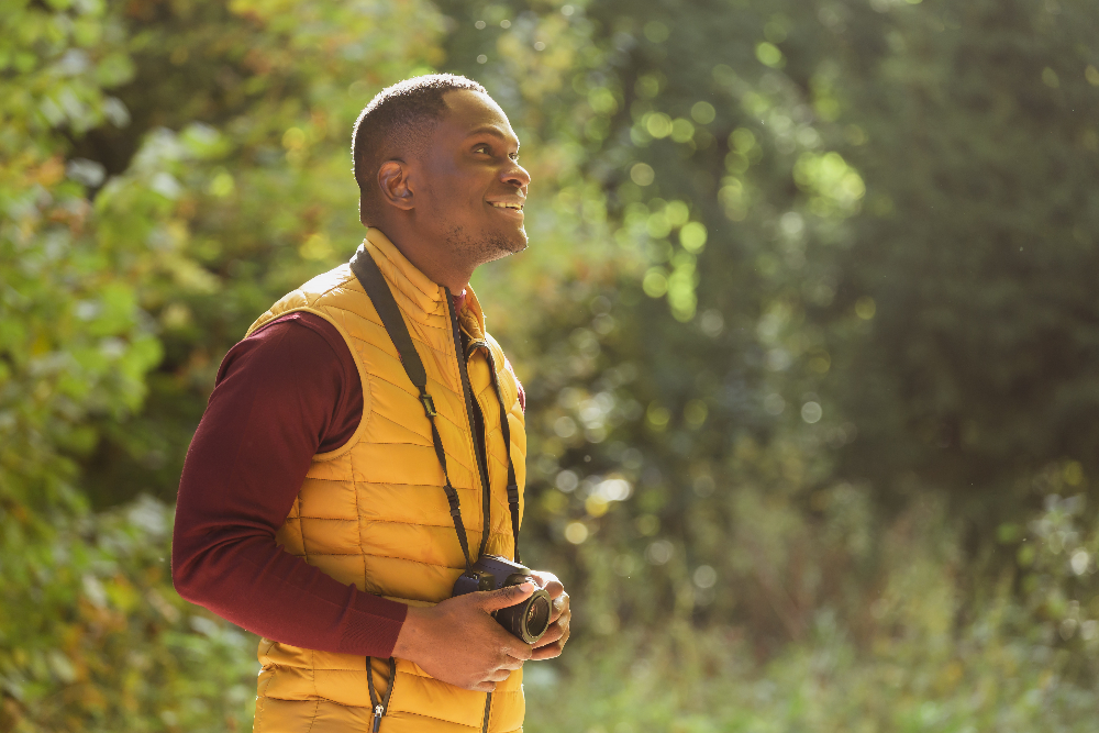 man standing outside with camera