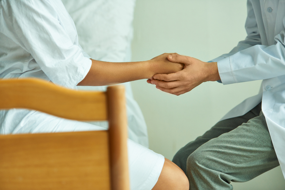 therapist and patient holding hands for comfort during therapy session