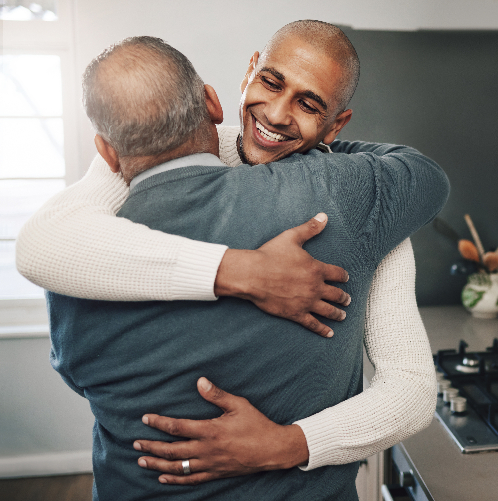 man and dad hugging while smiling