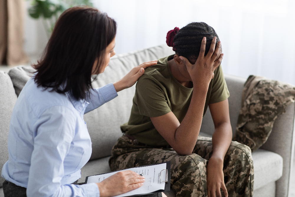 therapist meeting with woman struggling with ptsd from serving in the military