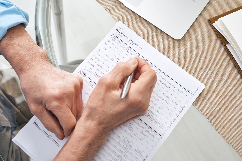 man filling out health insurance form