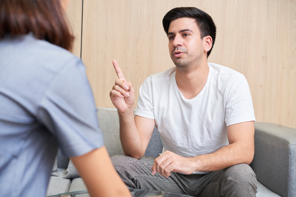 man talking with therapist during humanistic therapy session