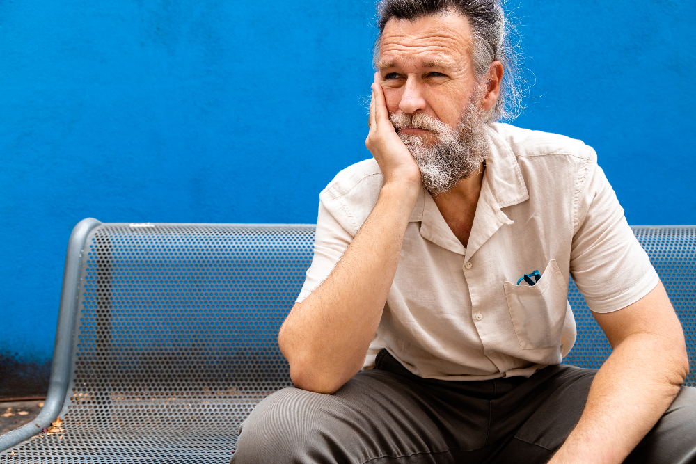 man sitting on a bench with depression