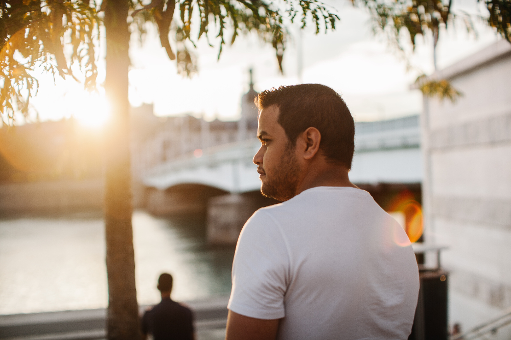 man standing outside during sunset next to a river  mental health treatment in sacramento