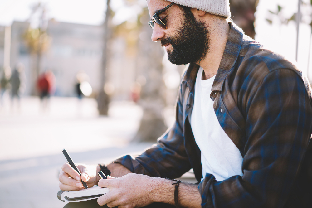 man journaling and practicing mindfulness outside in sacramento california