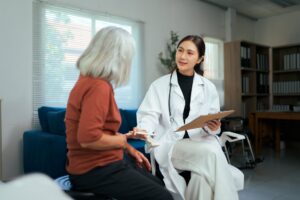 A clinician consulting oneonone with a patient in a bright office