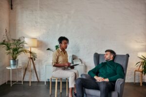A man in a therapy session talking with a therapist