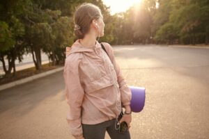 A woman walking outdoors in morning light, staying active and engaged