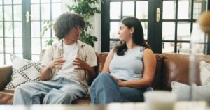 Two adults having a calm, supportive conversation on a couch