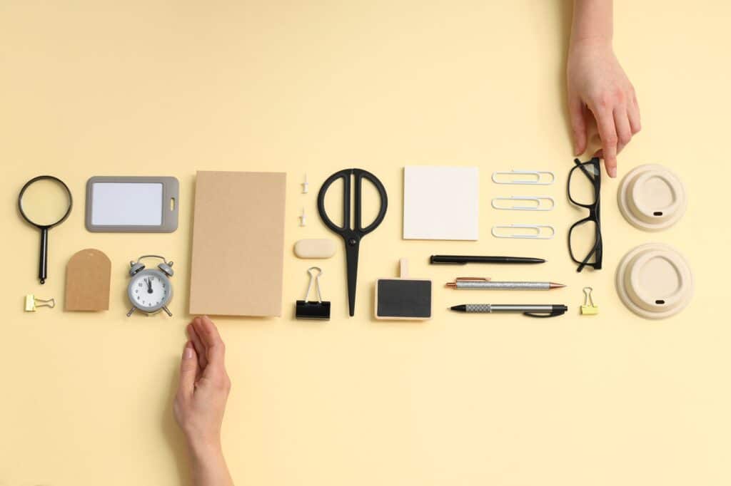 Hands arranging objects neatly in an orderly row