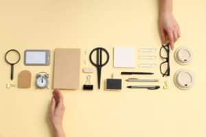 Hands arranging objects neatly in an orderly row